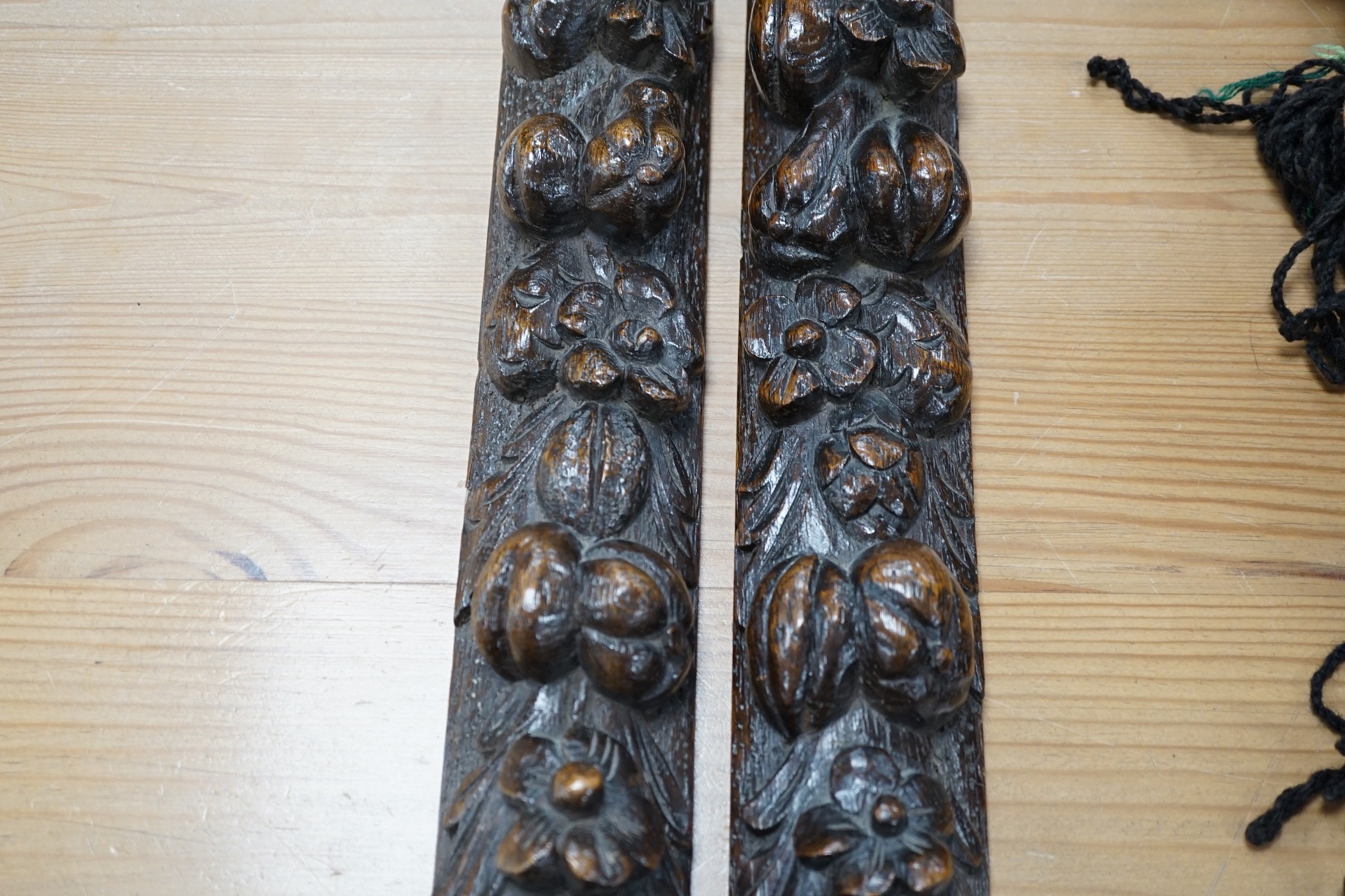 A pair of early carved wood hanging mouldings in the Flemish style, 81cm tall